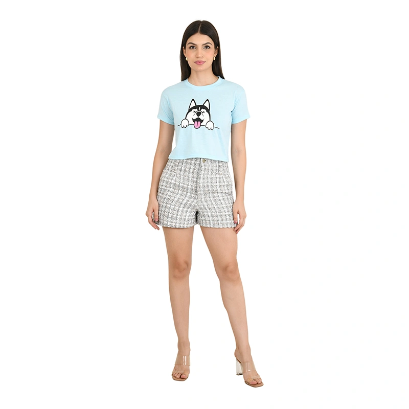 Female model in light blue graphic crop top and grey checkered shorts - western wear ecommerce photography by Lohar Studio Delhi